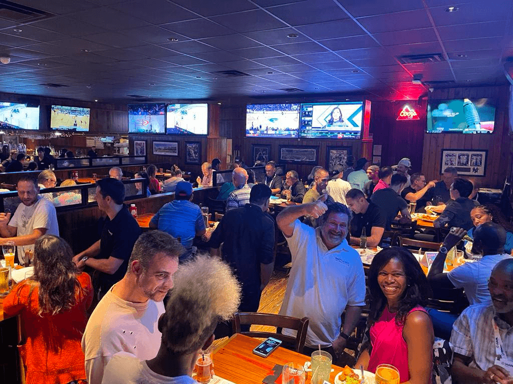 Foto Master customers gathering at tables during an evening mixer