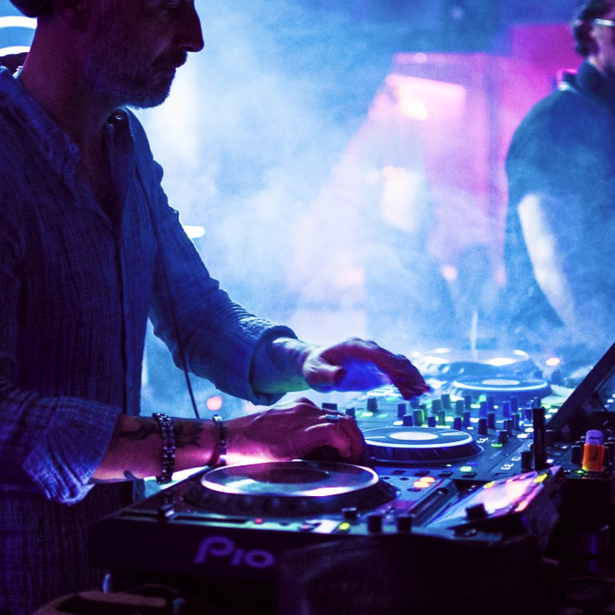 DJ at console - illustrating that photo booths are offered and suitable for DJs industries.