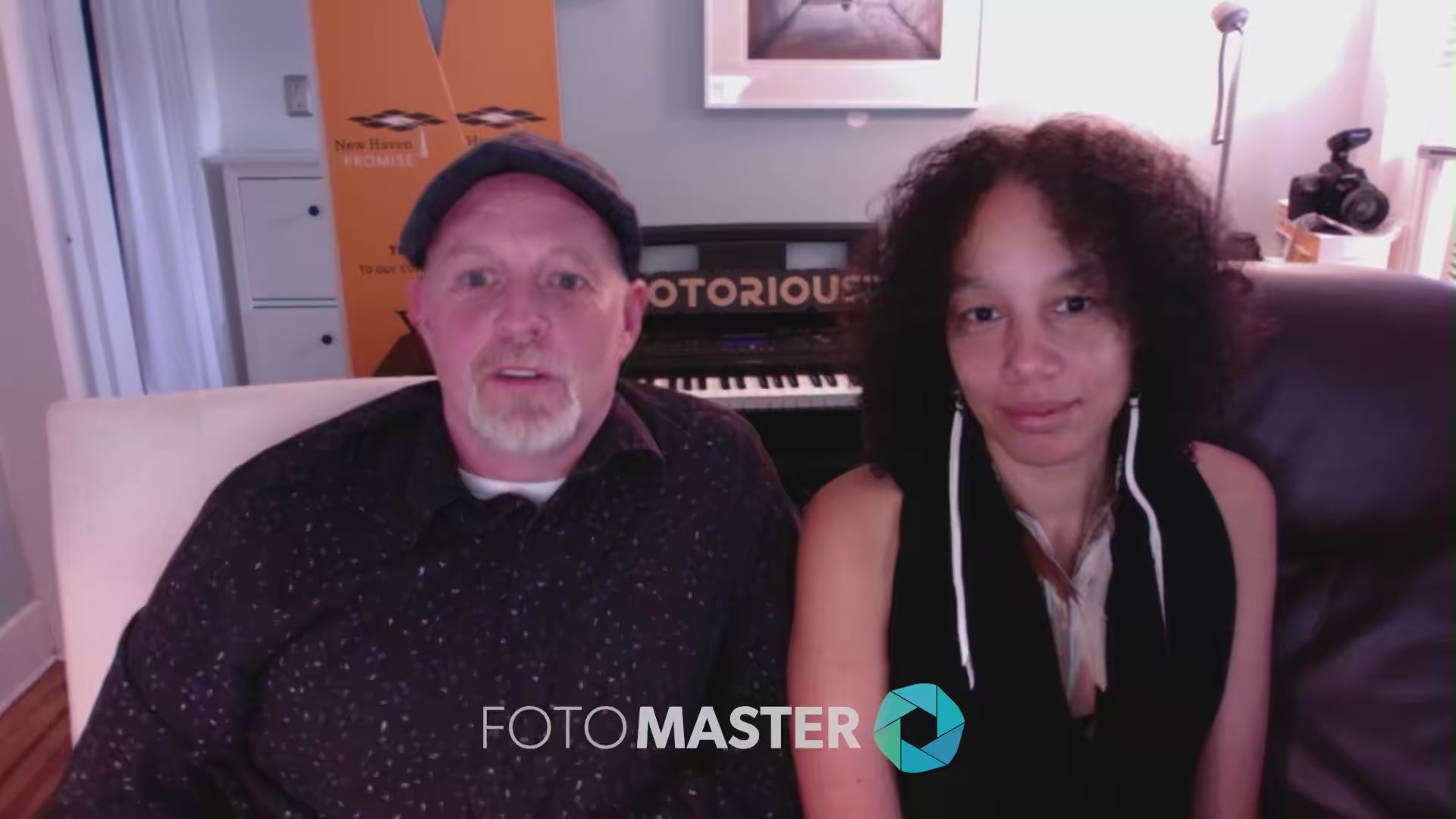 Man with beard (Chris Randall) and woman with curly hair (Teresa Joseph), of The Notorious P.I.C, in testimonial video.